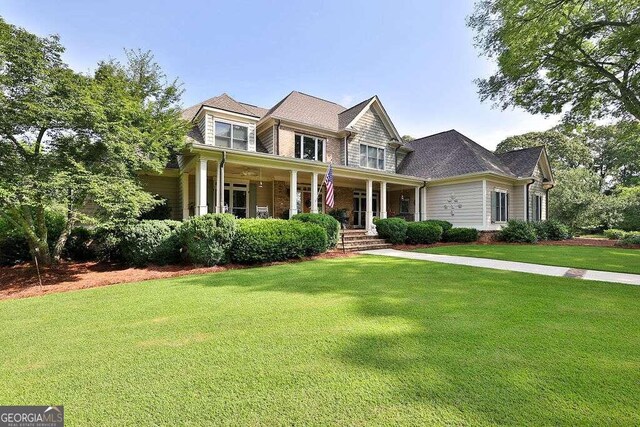 view of front of property with a front yard and covered porch