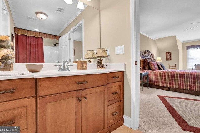 bathroom featuring a shower, vanity, and ornamental molding