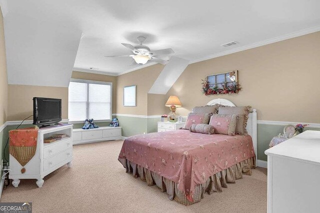 bedroom with ceiling fan, light carpet, and ornamental molding