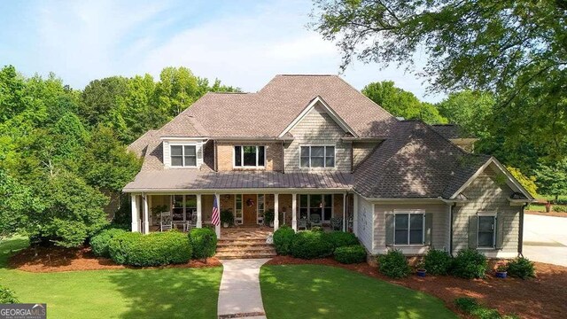 view of front of property featuring a front yard and covered porch