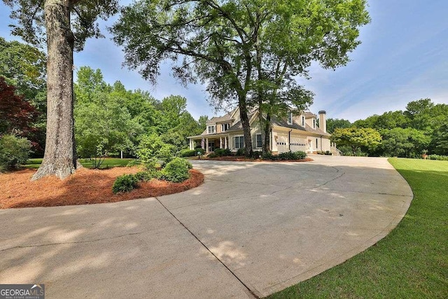 view of front facade featuring curved driveway and an attached garage