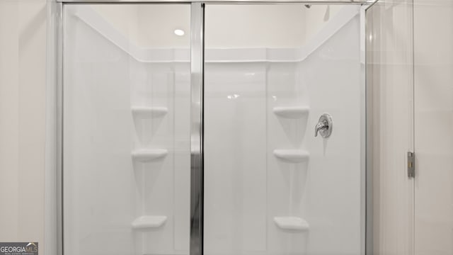 bathroom with a shower with shower door