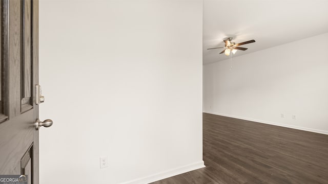 spare room with ceiling fan and dark hardwood / wood-style flooring