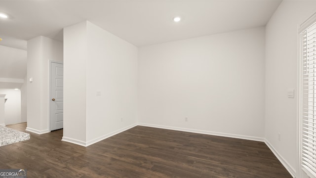 spare room featuring dark wood-type flooring