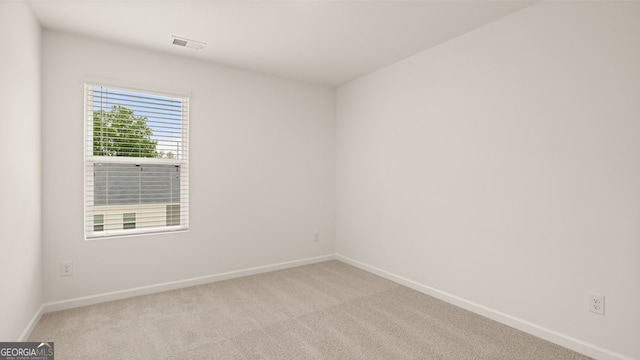 spare room with light colored carpet