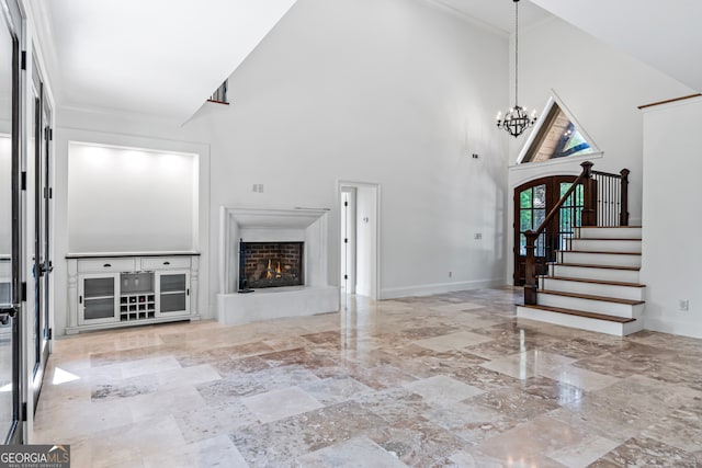 unfurnished living room with high vaulted ceiling and a chandelier