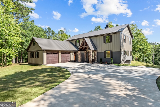 view of front of house featuring central AC unit, a garage, and a front lawn