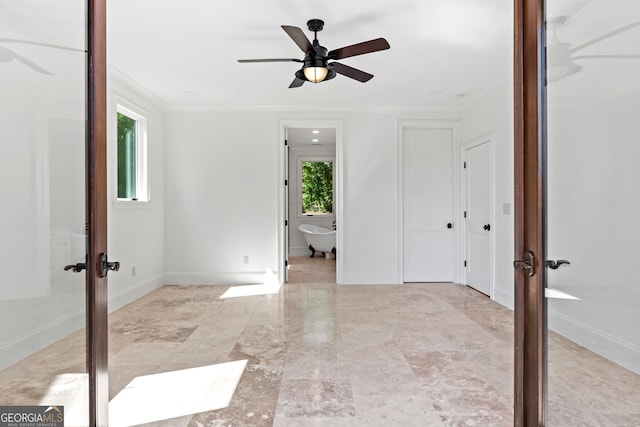 unfurnished room with ceiling fan, french doors, and ornamental molding