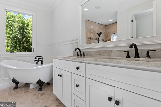 bathroom with a bathtub, ornamental molding, and vanity