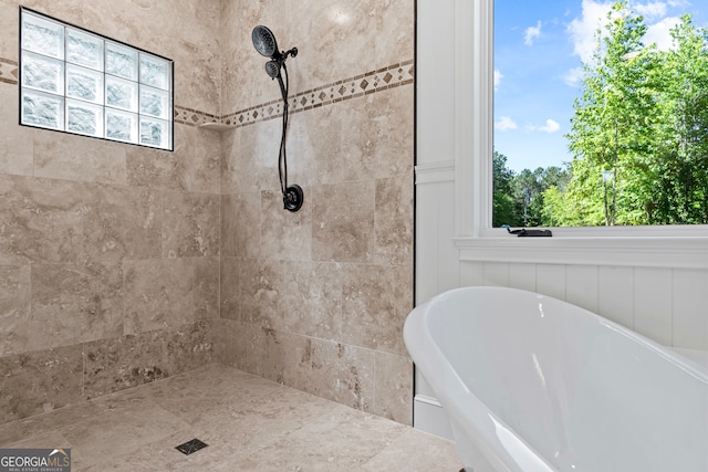 bathroom with a healthy amount of sunlight and separate shower and tub