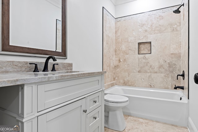 full bathroom featuring vanity, tiled shower / bath combo, and toilet