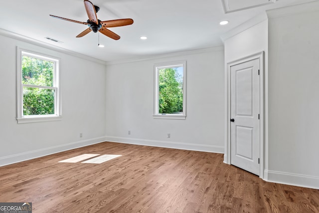 unfurnished room featuring crown molding, hardwood / wood-style floors, a wealth of natural light, and ceiling fan