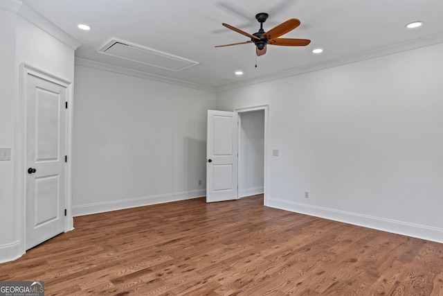 spare room with hardwood / wood-style flooring, crown molding, and ceiling fan