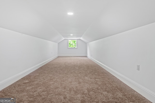 bonus room with carpet floors and vaulted ceiling