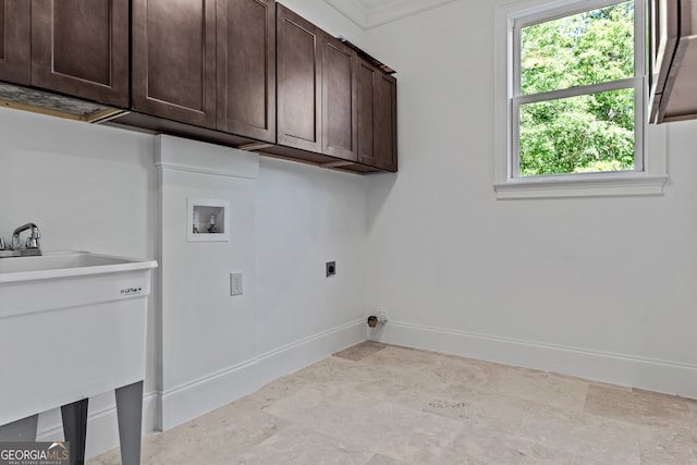 laundry area with hookup for a washing machine, hookup for an electric dryer, and cabinets