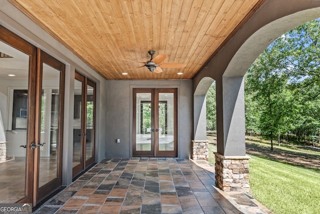 doorway to property with french doors, a patio, and ceiling fan