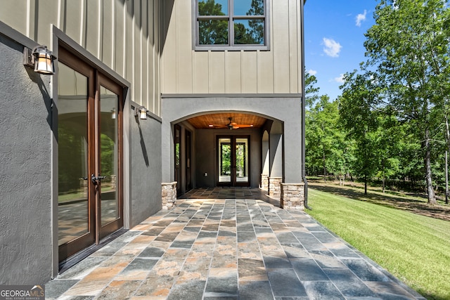 property entrance with a yard, french doors, and a patio area