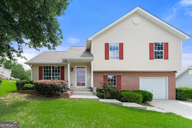 tri-level home featuring a garage and a front yard