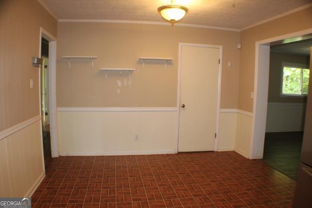 unfurnished room with crown molding