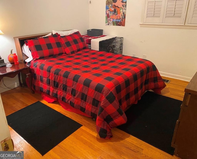 bedroom featuring wood-type flooring