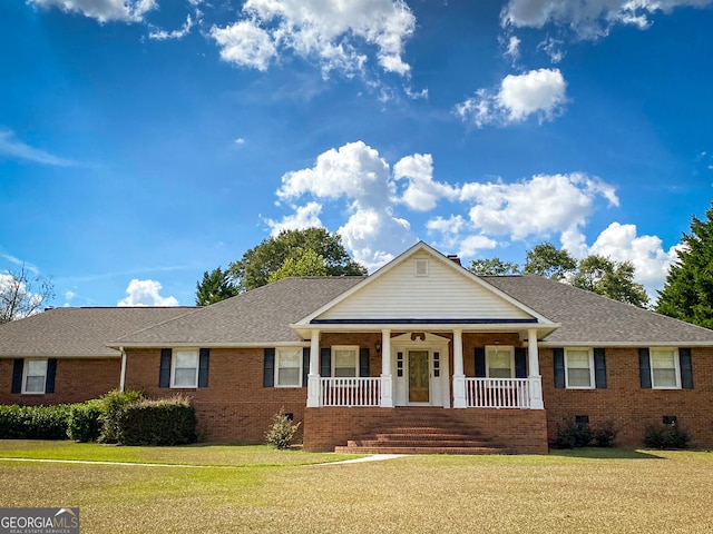 view of front facade with a porch and a front yard