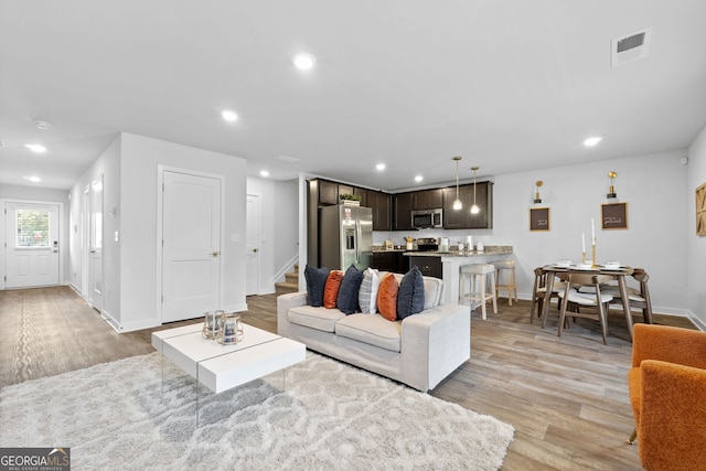 living room with light hardwood / wood-style flooring