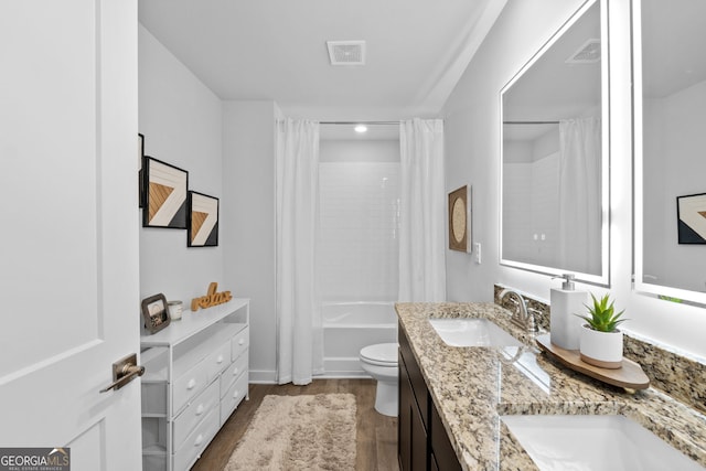 full bathroom with toilet, wood-type flooring, shower / bath combo with shower curtain, and vanity