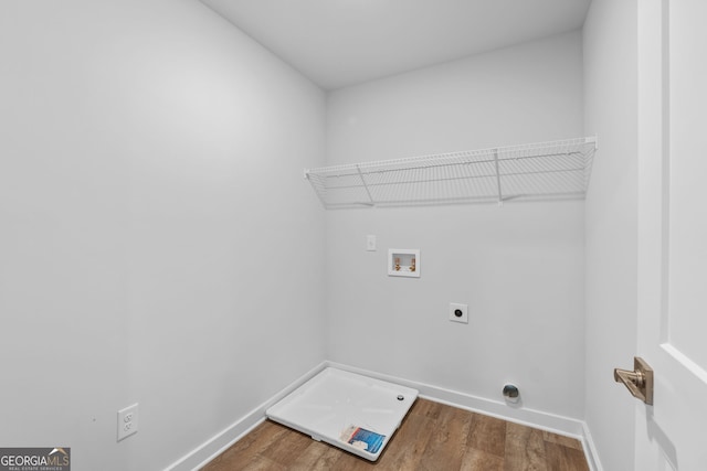 clothes washing area with washer hookup, wood-type flooring, and hookup for an electric dryer