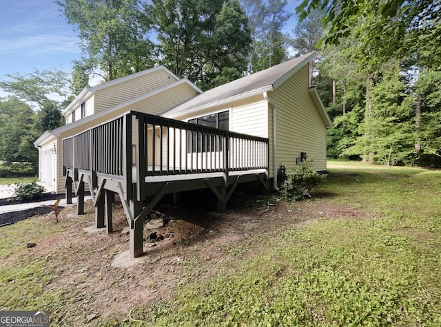 view of side of home with a lawn and a deck