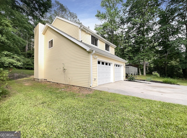 view of side of home featuring a yard and a garage