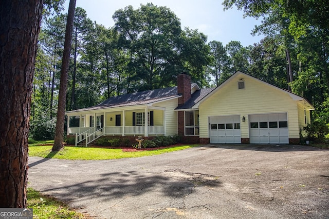 ranch-style house featuring a garage and covered porch