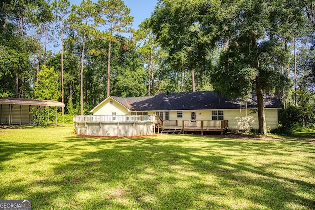 back of house with a yard and a swimming pool side deck