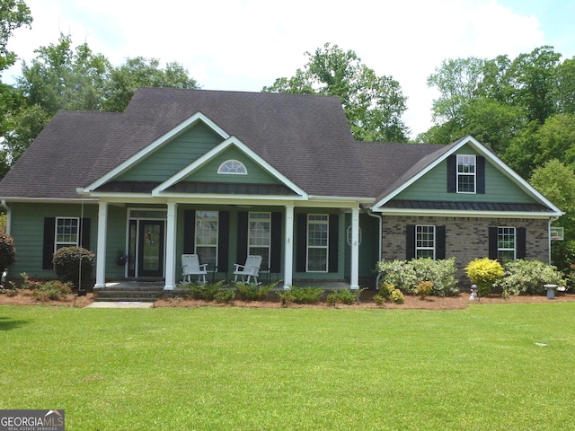 craftsman inspired home featuring a porch and a front lawn