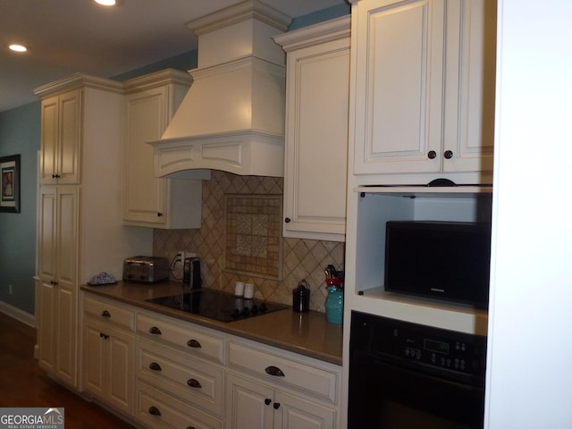 kitchen with custom exhaust hood, black appliances, and tasteful backsplash