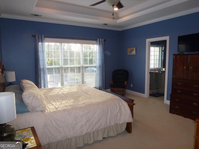 carpeted bedroom featuring ceiling fan, ornamental molding, and a raised ceiling