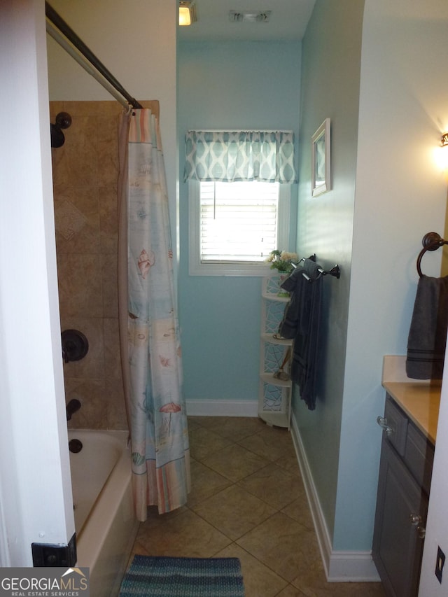 bathroom with vanity, tile patterned floors, and shower / bath combo with shower curtain