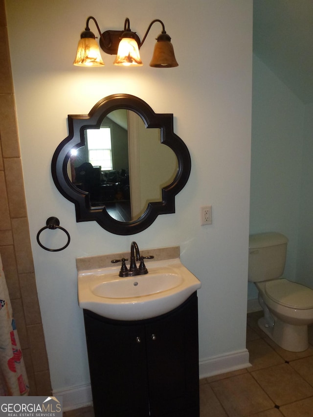 bathroom featuring toilet, vanity, and tile patterned floors