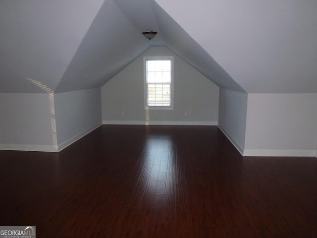 bonus room with lofted ceiling and dark hardwood / wood-style floors