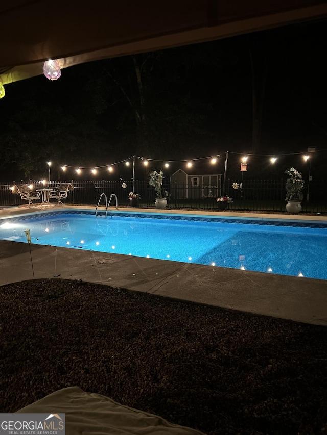 view of pool at night