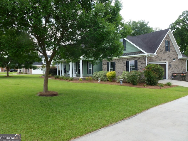 view of front of property featuring a front yard and a garage