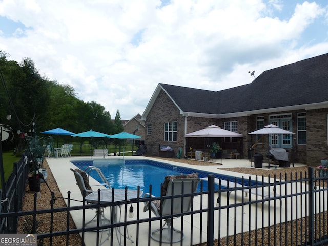 view of swimming pool featuring a patio area