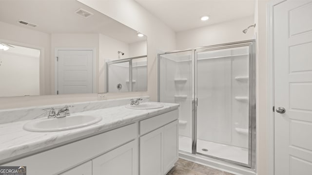 bathroom with vanity, an enclosed shower, and tile patterned flooring