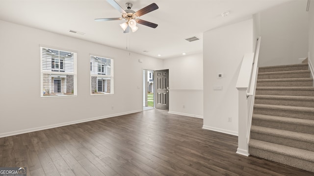 unfurnished living room featuring ceiling fan and dark hardwood / wood-style floors