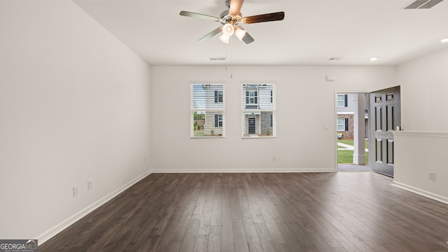 unfurnished room with ceiling fan, a wealth of natural light, and dark hardwood / wood-style flooring