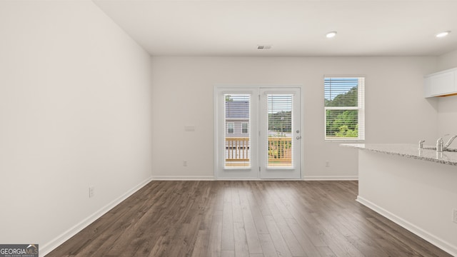 unfurnished dining area with dark wood-type flooring and sink