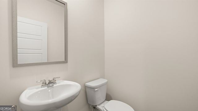 bathroom featuring toilet and sink