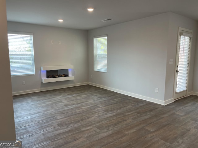 unfurnished living room featuring dark hardwood / wood-style flooring