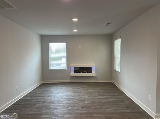 unfurnished living room featuring dark wood-type flooring