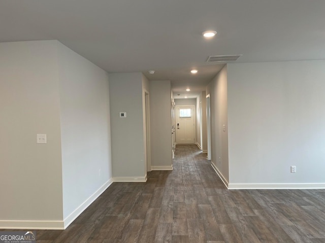 corridor with dark hardwood / wood-style flooring