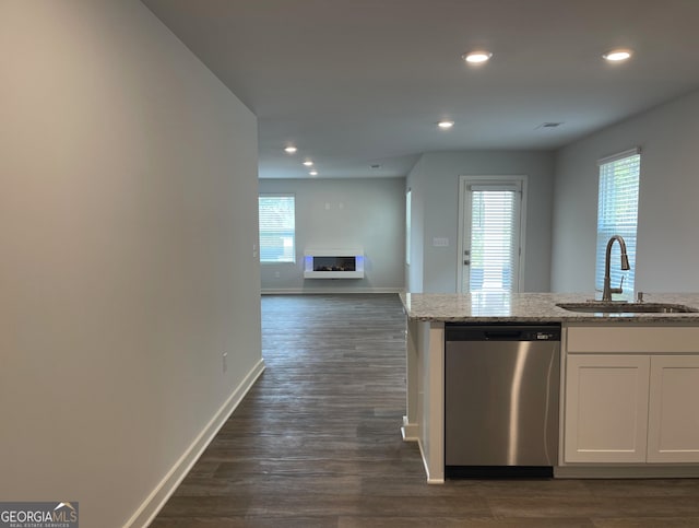 kitchen featuring white cabinetry, stainless steel dishwasher, plenty of natural light, and dark wood-type flooring